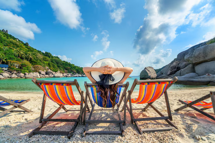 woman-with-hat-sitting-chairs-beach-beautiful-tropical-beach-woman-relaxing-tropical-beach-koh-nangyuan-island_335224-1110
